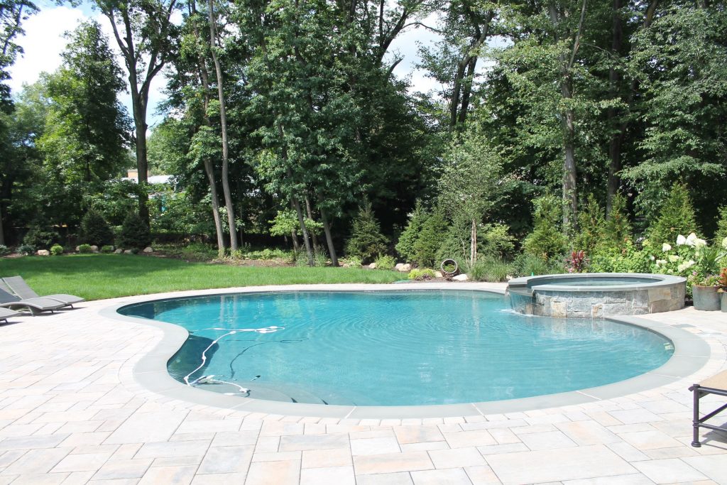 Stone Pool Deck and Spa installed by Curti's Landscaping