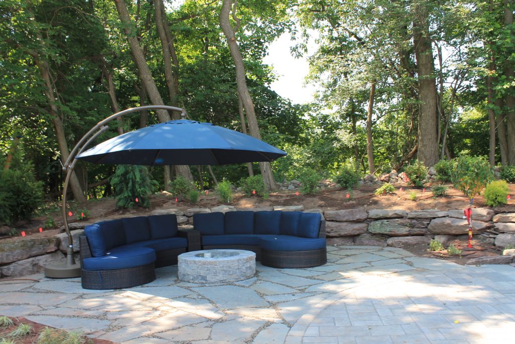 stone patio with fire pit and landscaping